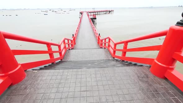 Long Red Japanese Styled Sea Bridge Lays into the Sea