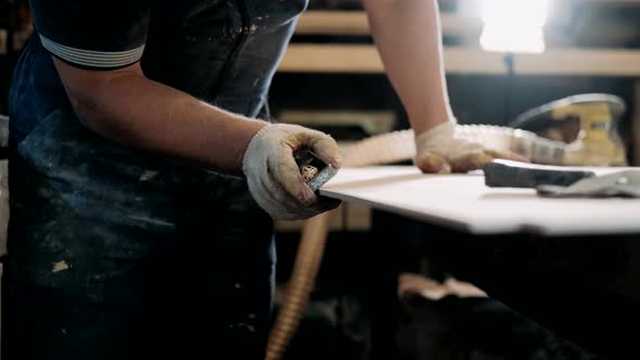 Carpenter sanding wood with sandpaper. Carpentry, craftsmanship, Handicrafts.