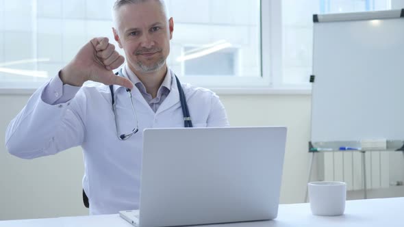 Thumbs Down by Doctor Looking at Camera