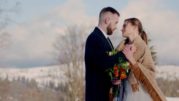 Couple on the Background of Snowcapped Mountains