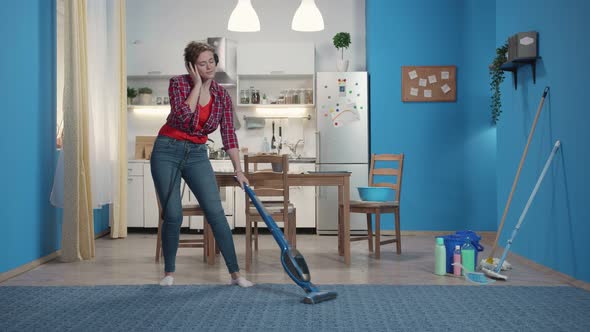 Housewife Cleans in the Kitchen and Sings Loudly