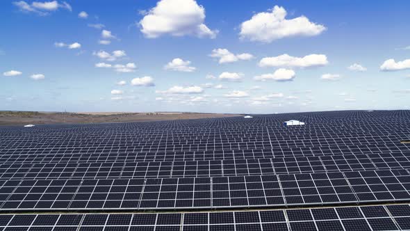 Green Field with Solar Energy Panels for Renewable Electricity Production Aerial View