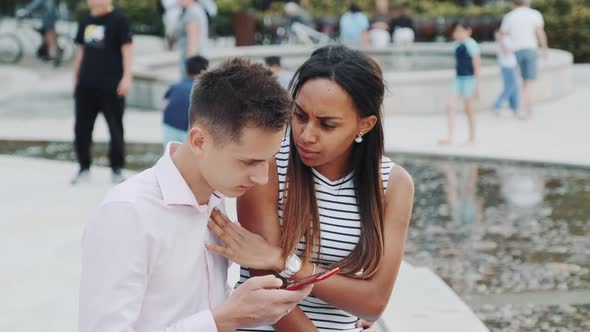 Mixed-race Girl Asking Her Boyfriend To Stop Looking in the Smartphone All the Time