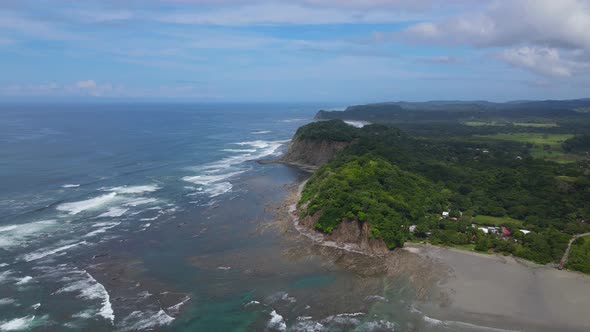 Aerial view moving forward shot, Scenic view of the Amazon river beside a mountain and the community