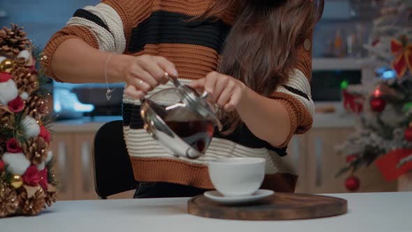 Portrait of Woman Pouring Coffee in Festive Kitchen