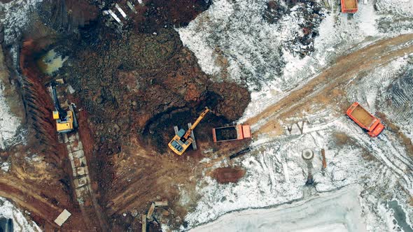 Excavator Work at a Career, Loading Trucks. Industrial Machinery Working at a Construction Site