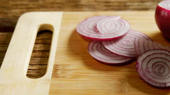 Sliced and halved onions on chopping board 4k