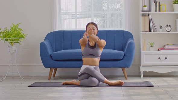 Calm of Asian woman in sportwear stretching muslce to warm up breathing and meditation