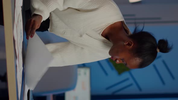 African Manager Woman Working with Financial Documents Standing at Desk