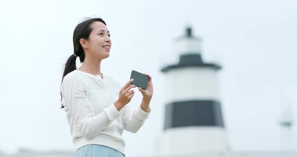 Woman use of cellphone to take photo at outdoor