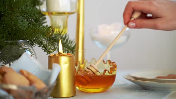 WOman Pouring Honey in Glass Bowl