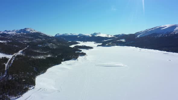 Tunhovdfjorden freshwater lake covered with ice during winter - Water reservoir for hydroelectric po