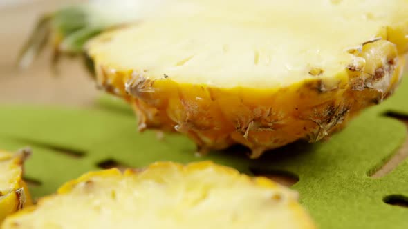 Halved pineapple on chopping board