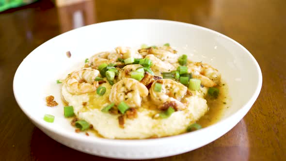 A plate of shrimp and grits steaming fresh and ready to eat