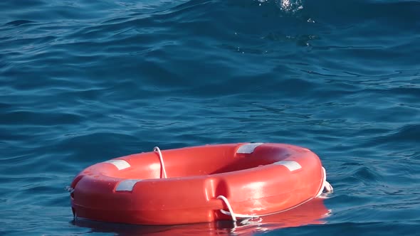 Life Buoy or Rescue Buoy Floating on Sea To Rescue People From Drowning Man. Slow Motion. Close Up