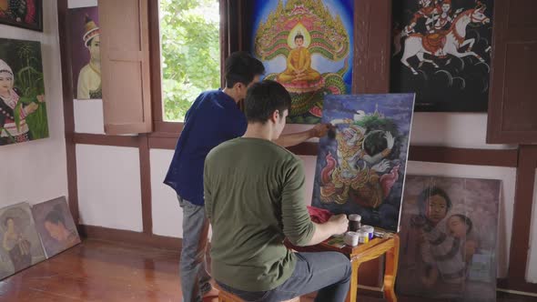 Young Man Painting In Art Studio With His Teacher