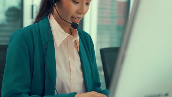 Businesswoman Wearing Headset Working Actively in Office