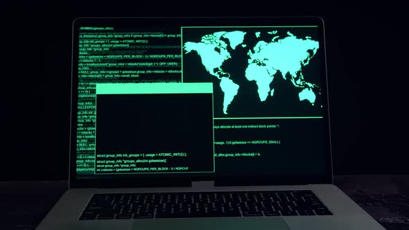 Hacker Concept. Code On A Laptop Computer Monitor In A Dark Room