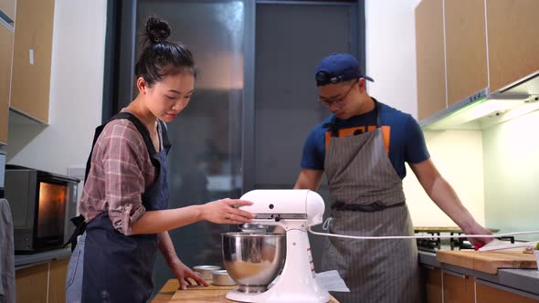 Young bakers making batter together at home