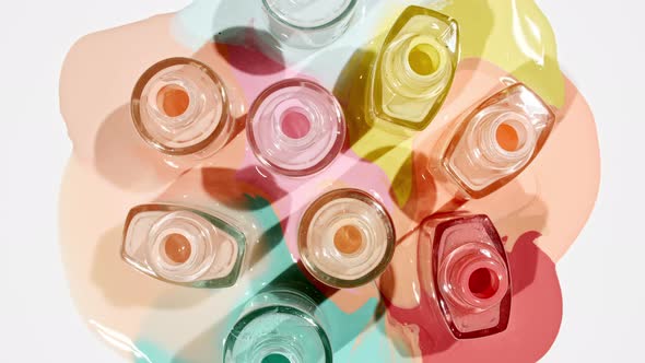 Multicolored Nail Polish Samples Spilled on White Background Isolated