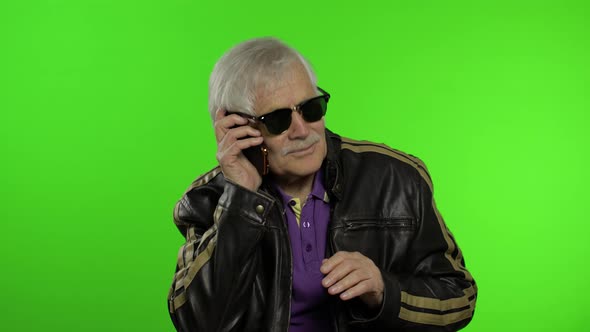 Elderly Stylish Caucasian Grandfather Man Dissatisfied Talking on Mobile Phone