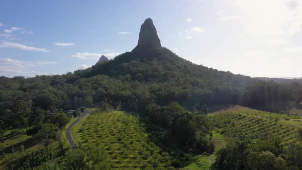 Glass House Mountains Mount Coonowrin bright sunny aerial with green farm, Queensland