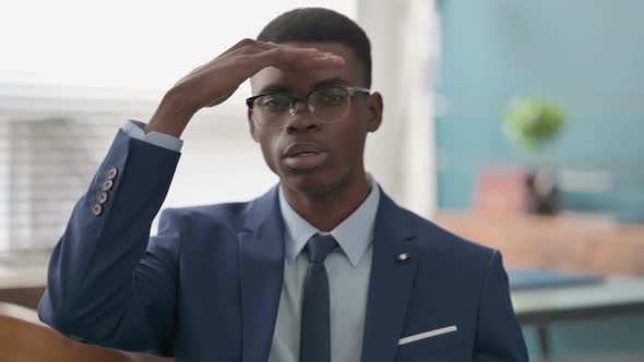 Young African Businessman Looking Around Searching