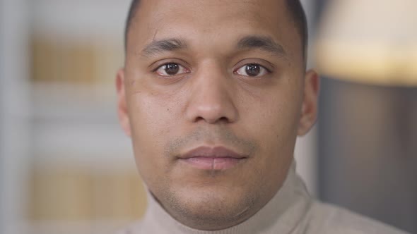 Headshot Portrait of Young Handsome African American Man with Brown Eyes Looking at Camera with