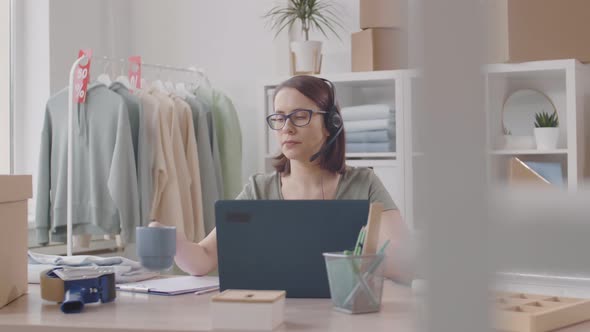 Saleswoman Working with Online Clients and Drinking Tea