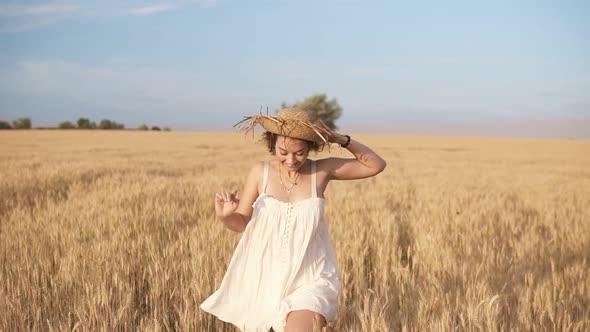 Gorgeous Young Woman in White Dress Runnung in the Wheat Field