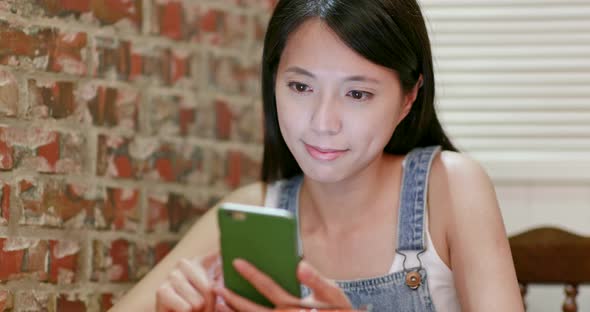 Woman use of mobile phone in coffee shop