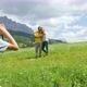 Boy (8 to 9) photographing parents in Alpine meadow, Alta Badia, Italy - VideoHive Item for Sale