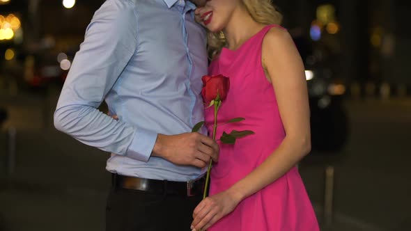 Girl Enjoying Aroma of Beautiful Rose, Present from Boyfriend on Date, Romance