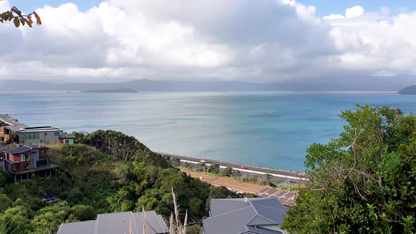 Wellington traffic commuting in and out of the capital on main state highway with blue ocean, harbou