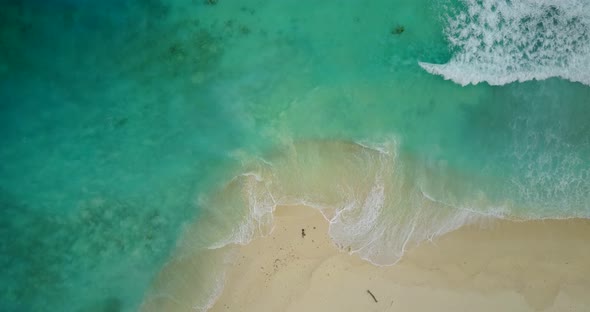 Luxury overhead travel shot of a paradise sunny white sand beach and aqua blue water background