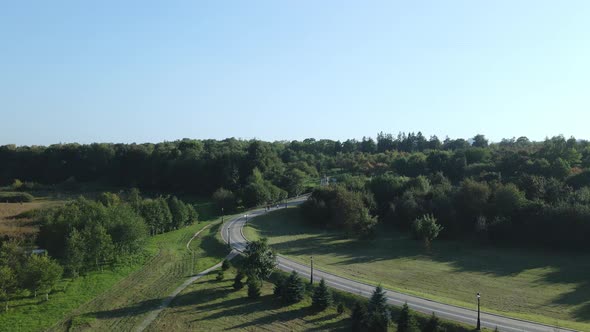 City landscape. Nearby there is a park area. Blue sky with white clouds. Aerial photography.