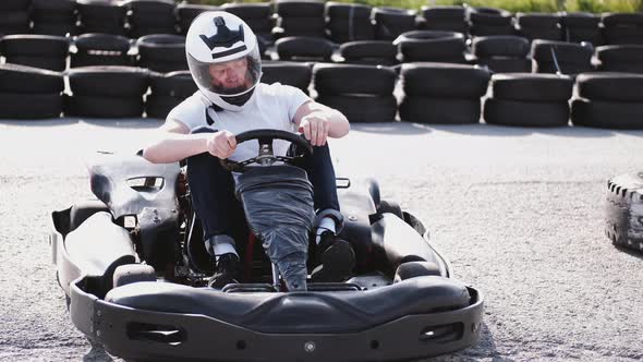 Attractive Man Sititng in a Gocart on the Track