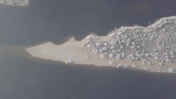 Winter Island in the Middle of River There are Trees in Frost on the Island