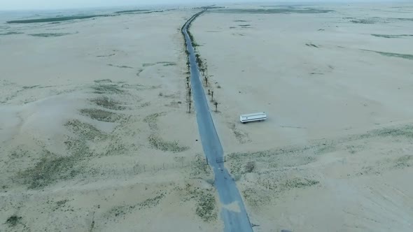  Flying over Dunes over  road and desert 