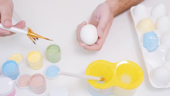 Close Up View of Man Painting Easter Eggs with Special Brush