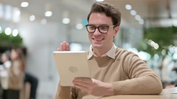 Man Celebrating Success Tablet in Office