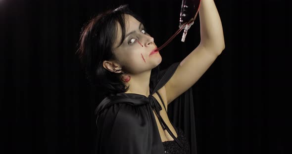 Vampire Halloween Makeup. Woman Portrait with Blood on Her Face.