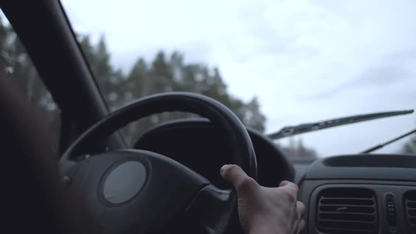 Driving a car with working windshield wipers. Cleaning a windscreen.