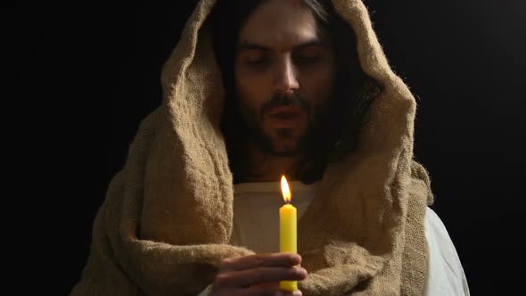 Crying Jesus in Robe Blowing Candle, Suffering From People Sins, Son of God