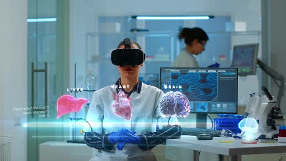 Female Scientist in Lab Wearing VR Goggles Working on Augmented Reality Virtual Holograms