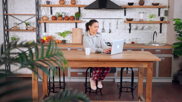 Middle Aged Woman Searching Internet at Home