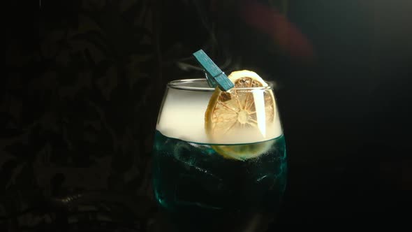 Alcoholic Drink With Lemon. Smoke. Close-up.