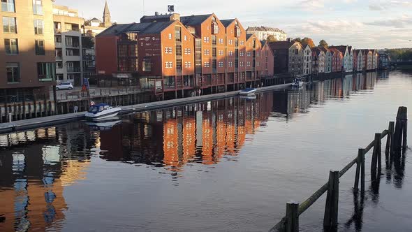 City Centre of Trondheim, Norway in calm evening light. Yachts and boats on the piers in River Nivel