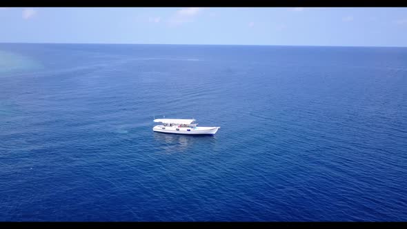 Aerial drone scenery of beautiful coast beach holiday by blue lagoon with bright sandy background of