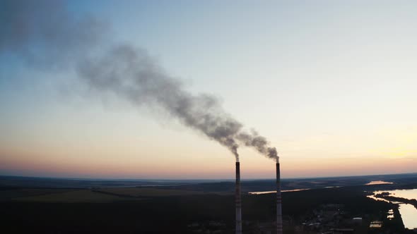 Smoke pipes of factory. Factory with chimneys expelling smoke into deep blue sky